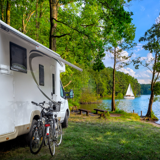 RV with bikes parked by a lake